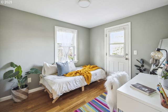 7615 SE 66th Ave, Portland, OR 97206 - bedroom with multiple windows, wood finished floors, and baseboards