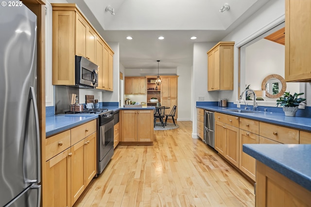 kitchen with light brown cabinets, light wood-type flooring, recessed lighting, appliances with stainless steel finishes, and a sink