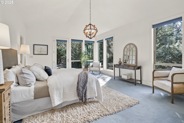 bedroom featuring a chandelier, carpet floors, and access to exterior