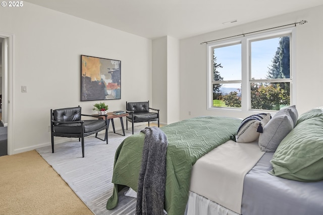 bedroom featuring baseboards and light carpet