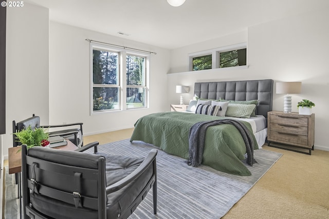 carpeted bedroom featuring visible vents and baseboards