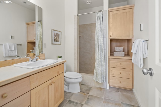 full bathroom featuring vanity, toilet, visible vents, and tiled shower