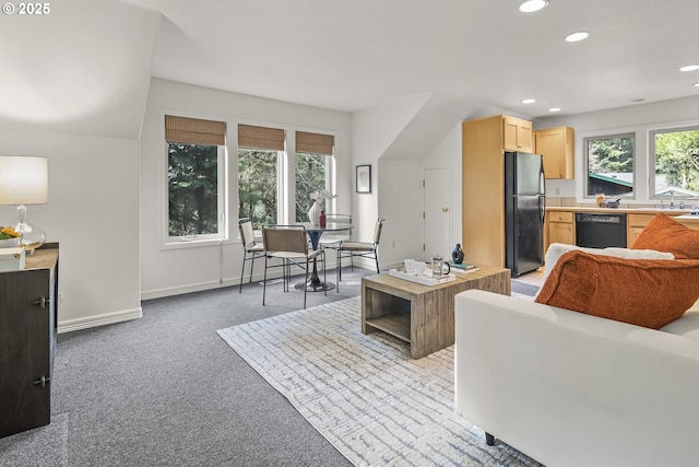 living room featuring recessed lighting, baseboards, and light carpet