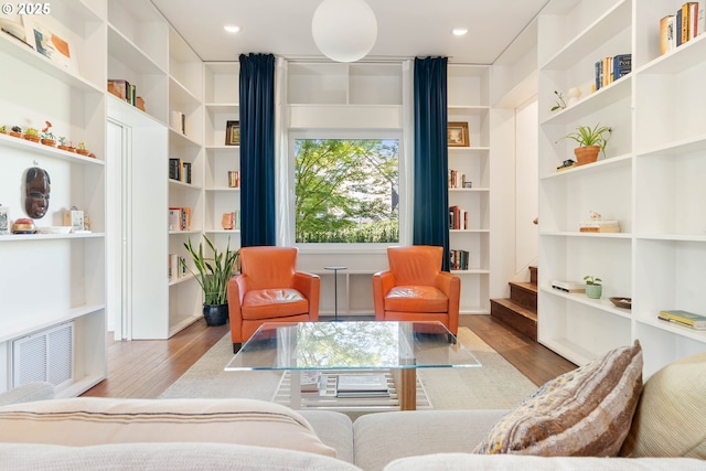 living area featuring wood finished floors and recessed lighting