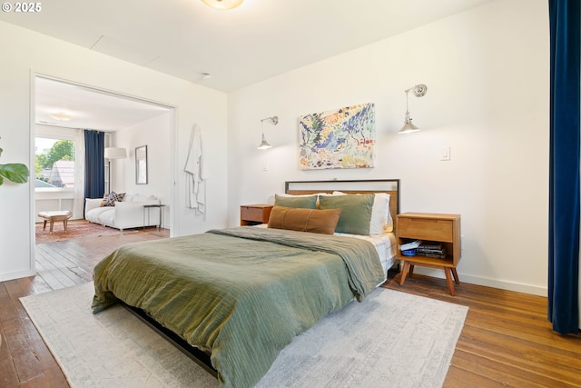 bedroom featuring hardwood / wood-style floors and baseboards