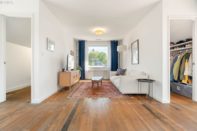 living area featuring hardwood / wood-style floors and baseboards