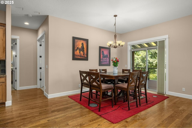 14746 SW 148th Ter, Tigard, OR 97224 - dining space with wood finished floors, a chandelier, and recessed lighting
