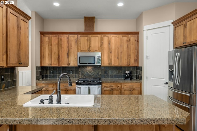 14746 SW 148th Ter, Tigard, OR 97224 - kitchen featuring appliances with stainless steel finishes, brown cabinets, tasteful backsplash, tile counters, and recessed lighting