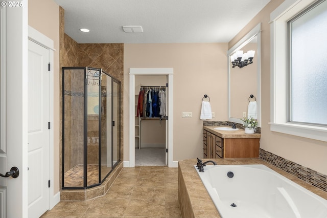 14746 SW 148th Ter, Tigard, OR 97224 - bathroom featuring a garden tub, a stall shower, vanity, and a spacious closet