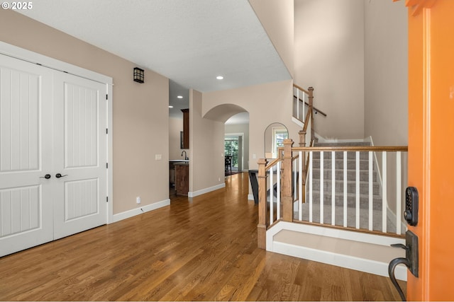 14746 SW 148th Ter, Tigard, OR 97224 - foyer entrance featuring arched walkways, wood finished floors, recessed lighting, and stairway