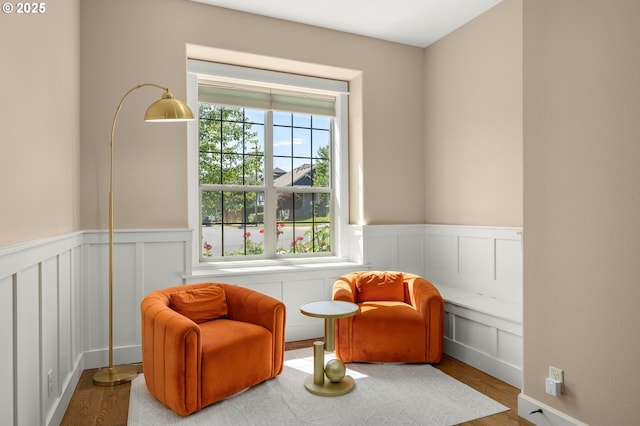14746 SW 148th Ter, Tigard, OR 97224 - living area featuring wainscoting, wood finished floors, and a decorative wall