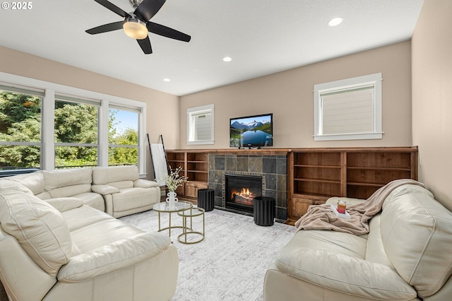 14746 SW 148th Ter, Tigard, OR 97224 - living area featuring recessed lighting, a tile fireplace, a ceiling fan, and wood finished floors