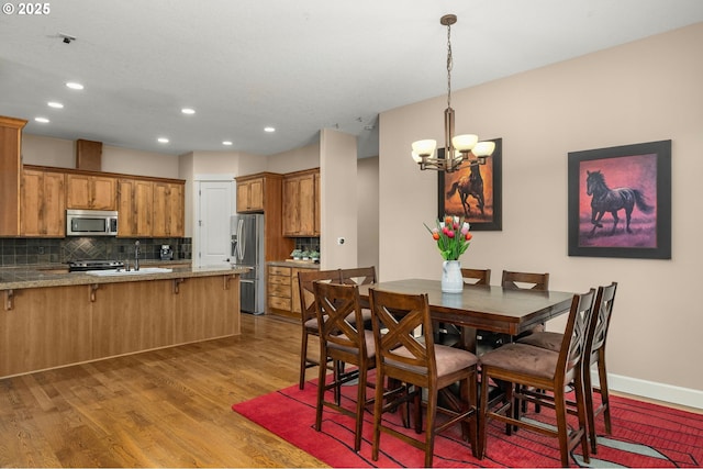 14746 SW 148th Ter, Tigard, OR 97224 - dining area featuring wood finished floors, a chandelier, and recessed lighting