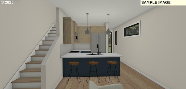 kitchen featuring sink, backsplash, kitchen peninsula, decorative light fixtures, and a breakfast bar area