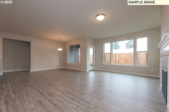 unfurnished living room featuring hardwood / wood-style floors