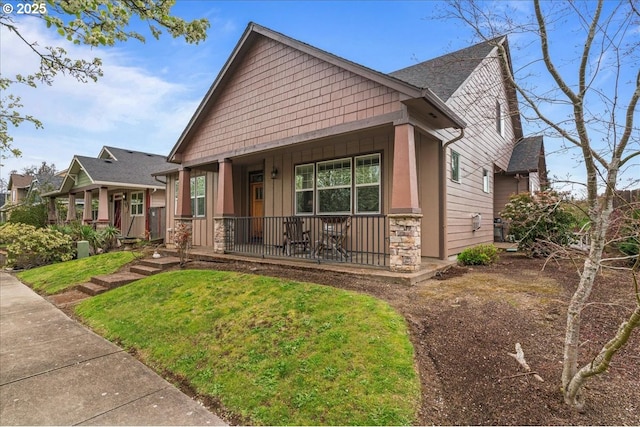1703 Webb Lake Dr, Silverton, OR 97381 - view of front of house with a front yard, covered porch, stone siding, and board and batten siding