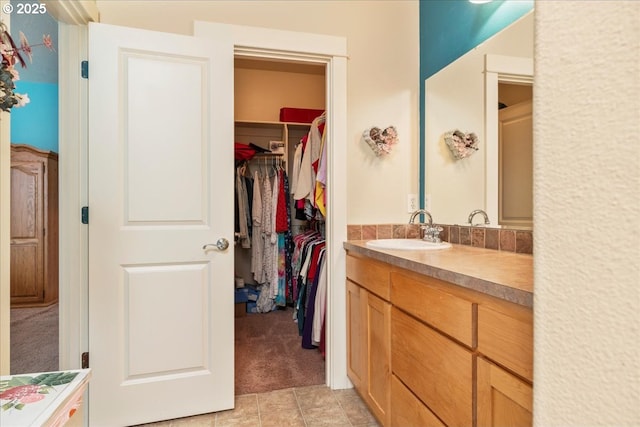 1703 Webb Lake Dr, Silverton, OR 97381 - bathroom with a walk in closet, tile patterned flooring, and vanity