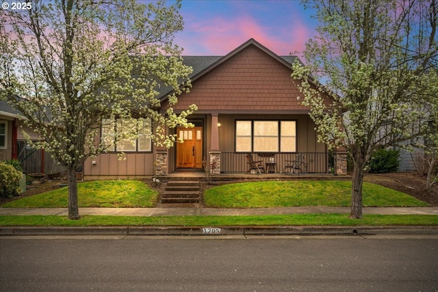 1703 Webb Lake Dr, Silverton, OR 97381 - view of front of home featuring stone siding, a porch, and a front lawn