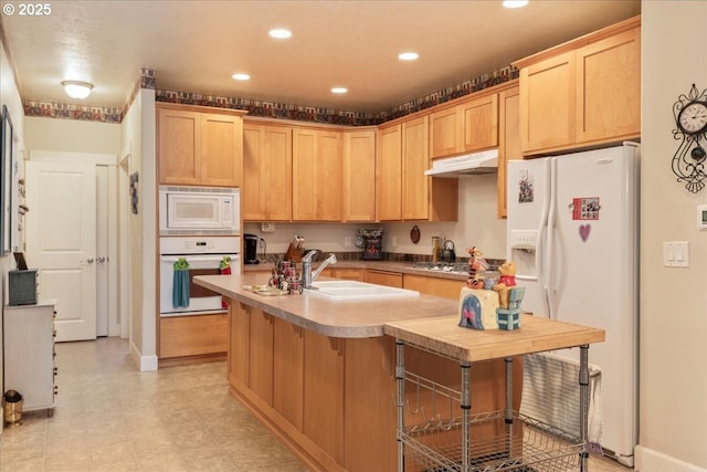 1703 Webb Lake Dr, Silverton, OR 97381 - kitchen with light brown cabinets, under cabinet range hood, recessed lighting, and white appliances