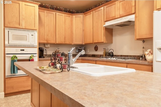 1703 Webb Lake Dr, Silverton, OR 97381 - kitchen with light tile patterned floors, light brown cabinets, under cabinet range hood, and white appliances
