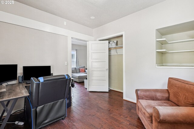 office with dark wood-type flooring and baseboards