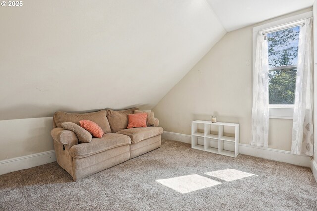 living area featuring baseboards, vaulted ceiling, and carpet flooring