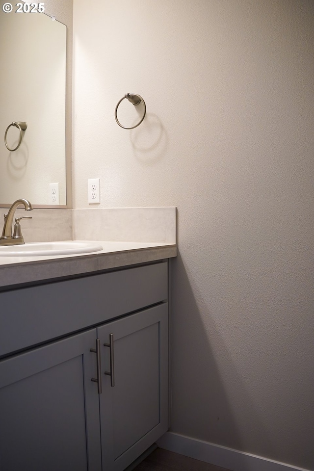 bathroom featuring vanity and baseboards