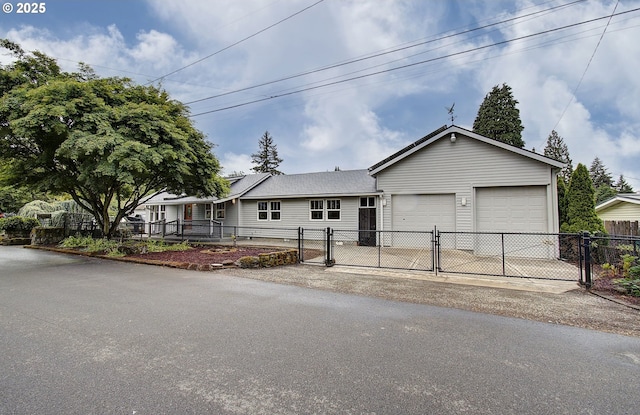 single story home with a gate, a garage, fence, asphalt driveway, and a shingled roof