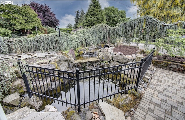 view of patio / terrace with a garden pond
