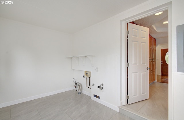 washroom featuring hookup for a gas dryer, hookup for a washing machine, baseboards, and light tile patterned floors