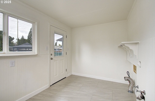 washroom with crown molding, baseboards, and light tile patterned flooring