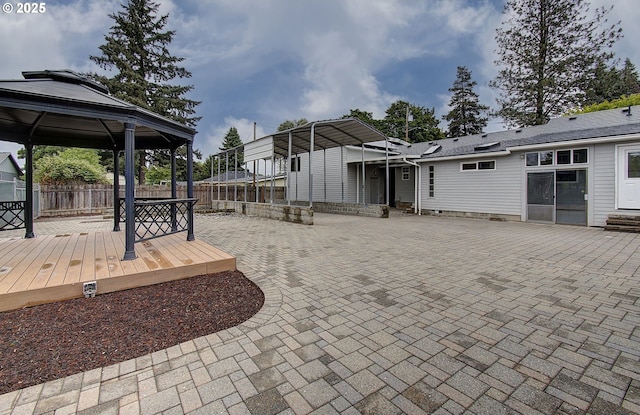 fenced backyard with a gazebo and a wooden deck
