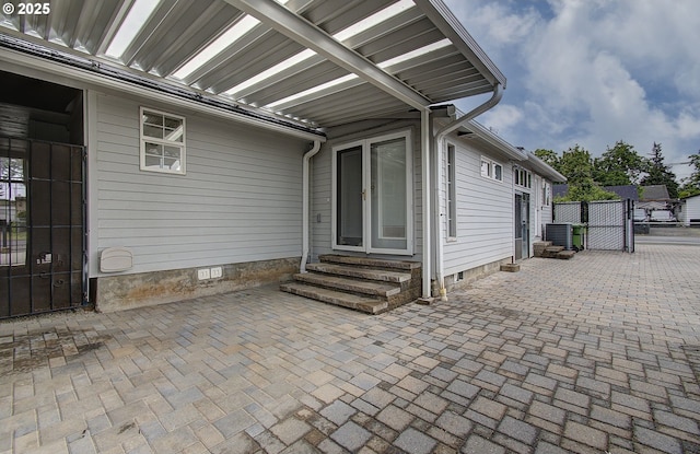 view of patio featuring entry steps, central AC unit, a gate, and fence