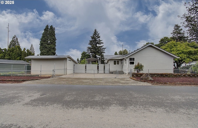 ranch-style home featuring a gate, fence, and driveway