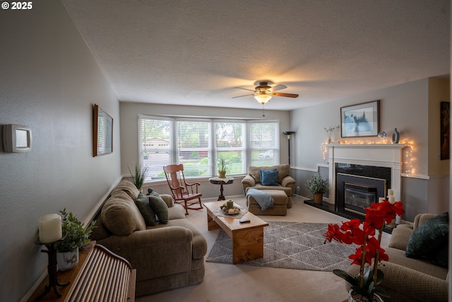 2580 Elysium Ave, Eugene, OR 97401 - carpeted living room featuring a ceiling fan, a high end fireplace, a textured ceiling, and baseboards