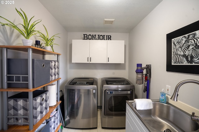 2580 Elysium Ave, Eugene, OR 97401 - laundry room with cabinet space, washing machine and clothes dryer, and light tile patterned flooring