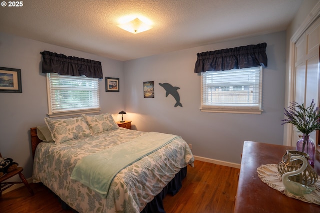 2580 Elysium Ave, Eugene, OR 97401 - bedroom with wood finished floors, baseboards, and a textured ceiling