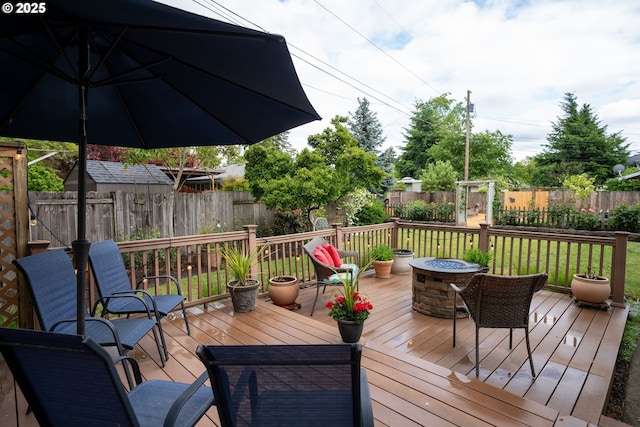 2580 Elysium Ave, Eugene, OR 97401 - deck with a fenced backyard and an outdoor fire pit