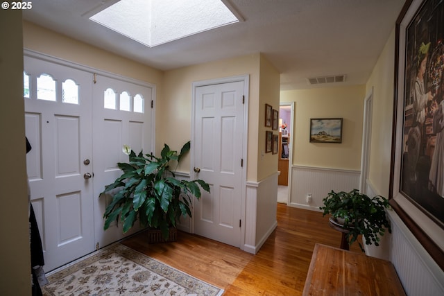 2580 Elysium Ave, Eugene, OR 97401 - foyer with light wood finished floors, a skylight, and wainscoting