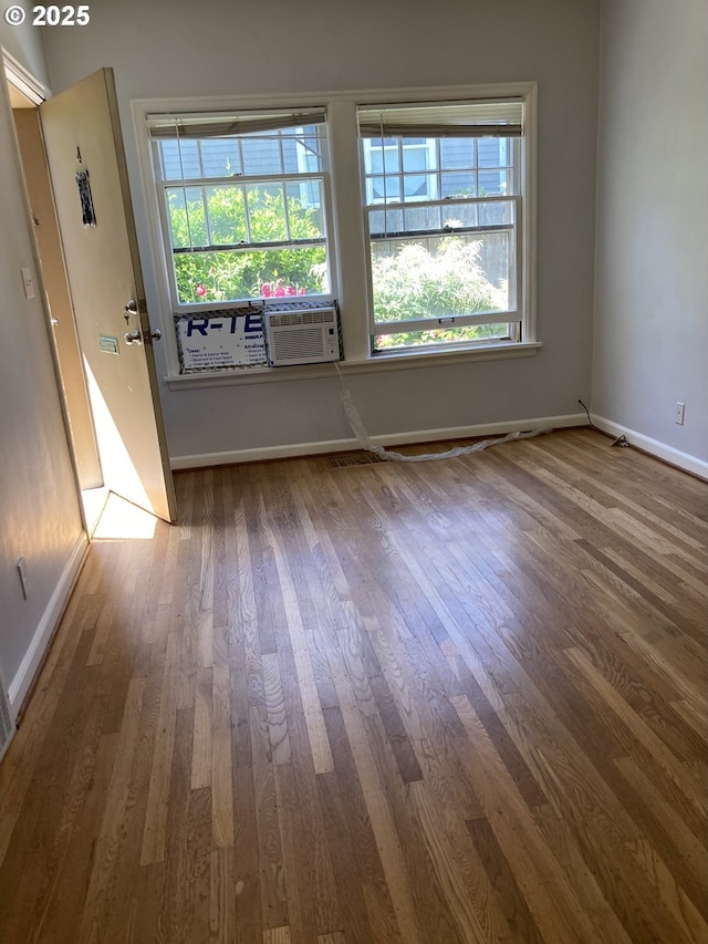 empty room with hardwood / wood-style flooring and cooling unit