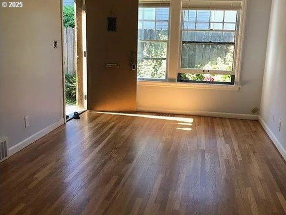 spare room with dark wood-type flooring