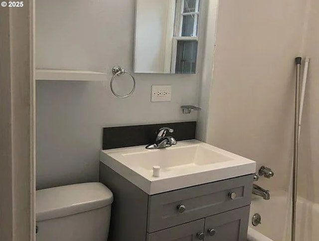 full bathroom featuring  shower combination, vanity, and toilet