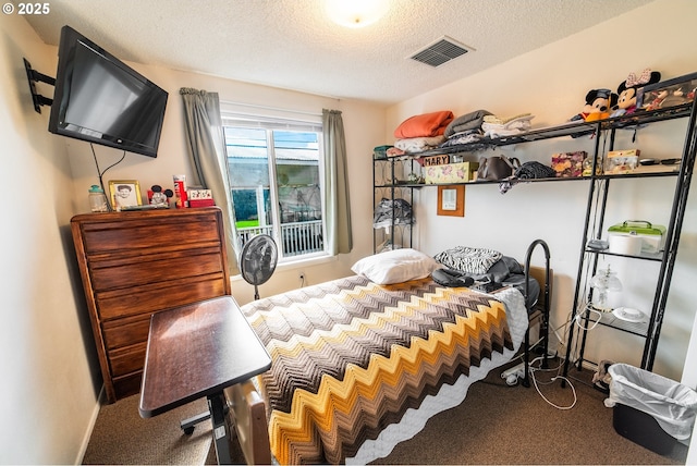 carpeted bedroom featuring a textured ceiling