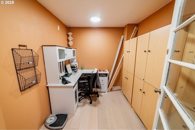 office area with light hardwood / wood-style floors