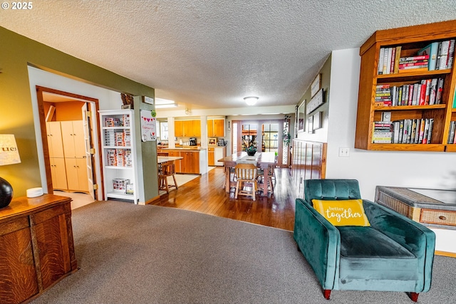 sitting room featuring light colored carpet and a textured ceiling