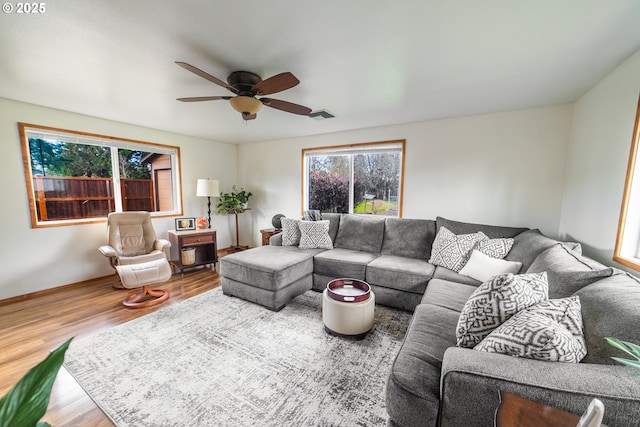 living room with hardwood / wood-style floors and ceiling fan