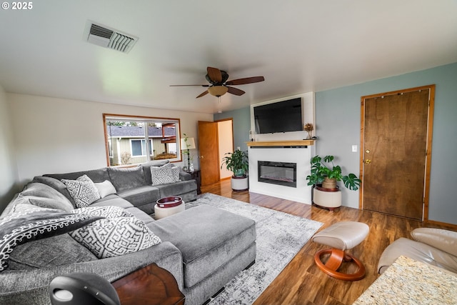 living room with hardwood / wood-style floors and ceiling fan