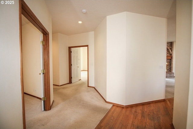 corridor with recessed lighting and baseboards