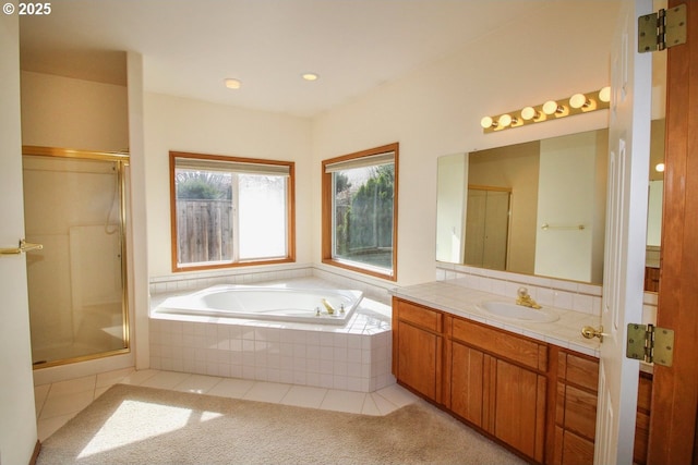 bathroom featuring a shower with door, tile patterned flooring, a bath, and vanity