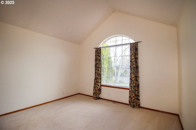 empty room with plenty of natural light, visible vents, and light carpet